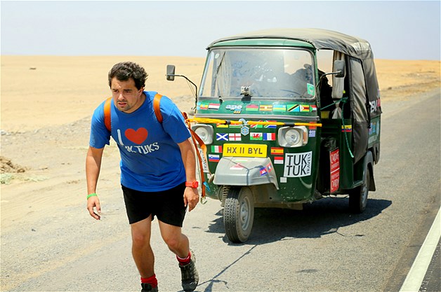 Two British teachers have broken the world record for the longest journey in a tuk-tuk after pushing their failing vehicle the last 43 miles. Here, Nick Gough is seen hauling the broken-down tuk-tuk in the Sechura Desert, Northern Peru, Nov. 25, 2013.