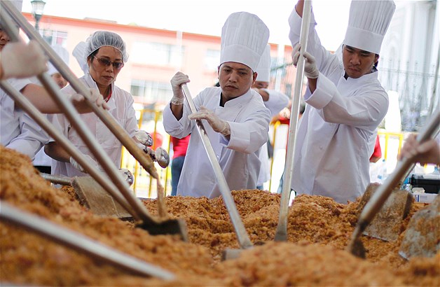 Chefs cook the "world's largest Cantonese fried rice" during Chinese Lunar New Year celebrations in Chinatown in San Jose, Costa Rica, Feb. 12, 2013. Some 52 chefs from various Chinese restaurants in Costa Rica cooked the rice, which weighed 2,965 lbs., and served over 7,000 people.