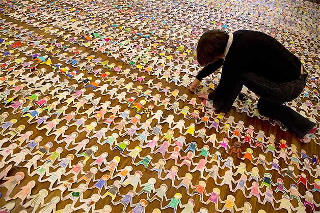 Staff from Macmillan Children's Books lay out paper dolls at the setting of a new Guinness World Record for longest chain of paper dolls at the Royal Festival Hall on Nov. 11, 2013, in London, England. The paper dolls were made by children from all over the world to coincide with the publication of best-selling children's author Julia Donaldson's book "The Paper Dolls."