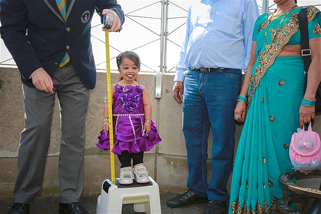 Jyoti Amge, 19, from Nagpur, India, is measured by a Guinness World Record official on top of the Empire State Building in New York, Sept. 12, 2013. Standing 24.7 inches tall, Amge has held the title of the "Shortest Living Woman" since her 18th birthday on Dec. 16, 2011.