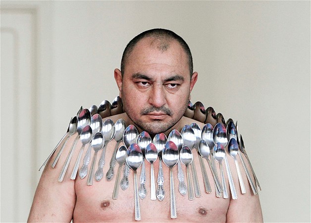 Etibar Elchiyev poses with 50 metal spoons magnetized to his body during an attempt to set the Guinness World Record for "most spoons on a human body" in Tbilisi, Georgia, Dec. 14, 2011.