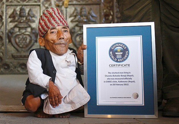 Chandra Bahadur Dangi, 72, poses for a picture with his certificate after being announced as the world's shortest man living, as well as shortest person ever measured by the Guinness World Records, in Kathmandu, Nepal, Feb. 26, 2012. Dangi was measured at 21.5 inches, beating former record holder Junrey Balawing of the Philippines, who stands at a height of 23.5 inches.