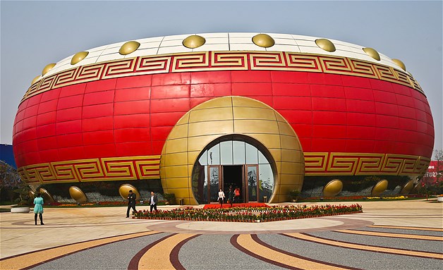 People leave the 59-foot-high drum-shaped building in Hefei, in east China's Anhui province, Nov. 4, 2013. The building is believed to be an attempt at setting a Guinness World Record for the world's largest drum-shaped building.