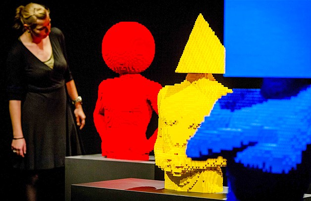 A woman looks at sculptures made out of Lego bricks during a preview of the exhibition ''The Art of the Brick'' held at the Amsterdam EXPO, in Amsterdam, Netherlands, May 27, 2014. The exhibition by New York-based artist Nathan Sawaya presents more than 70 artworks.