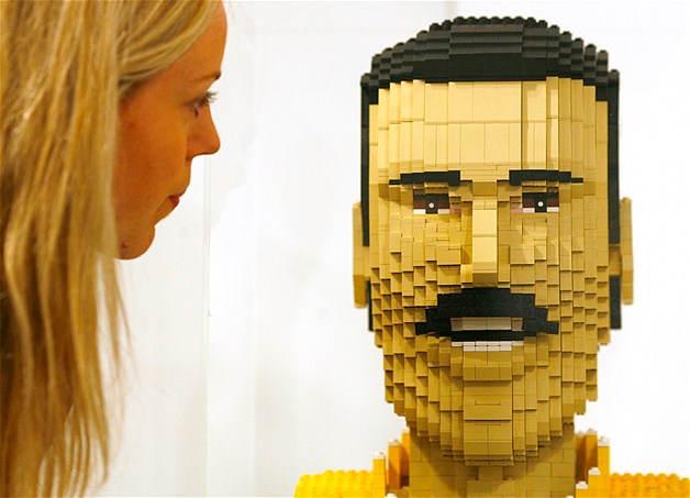 A gallery employee looks at "Freddie" by Craig Stevens, a Lego sculpture of singer Freddie Mercury, part of the "View Basket: Art Bought Online" at the Hayward Gallery in London, Aug. 28, 2008. The exhibition of more than 100 works, both amateur and professional, were all purchased on Ebay.