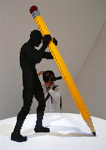 A visitor photographs "Writer" during the media preview of "The Art of the Brick" exhibition in Singapore, Nov. 15, 2012. The exhibition, which features New York artist Nathan Sawaya's 52 original Lego creations, was held at the Art Science Museum.