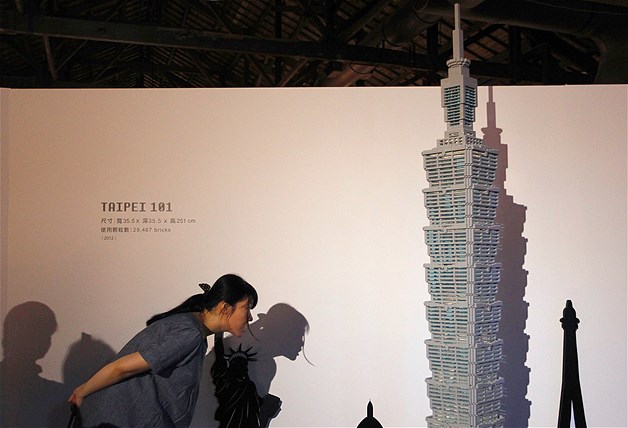 A visitor looks at a model of Taiwan's landmark building, Taipei 101, constructed out of Legos during the "The Art of the Brick" exhibition at the Huashan Creative Park in Taipei, Taiwan, July 14, 2012. The exhibition featured large Lego art works by New York Lego artist Nathan Sawaya.