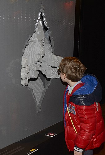A boy comes face-to-face with a sculpture by New York Lego artist Nathan Sawaya at his exhibition titled "The Art of the Brick" in Brussels, Belgium, April 18, 2014.