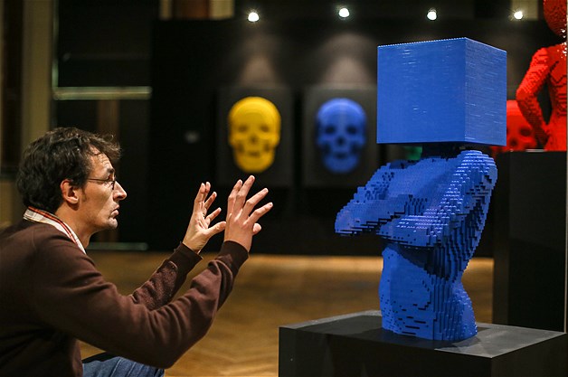 A visitor is seen next to a sculpture made out of Legos on display during the exhibition ''The Art of the Brick'' held at the Stock Exchange of Brussels, Belgium, Nov. 28, 2013. The exhibition by New York-based artist Nathan Sawaya featured more than 70 of his sculptures.