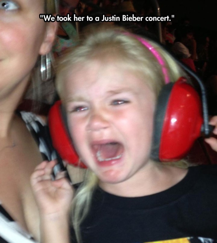 kid crying at concert - "We took her to a Justin Bieber concert."