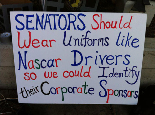 sign - Senators Should Wear Uniforms Nascar Drivers so we could Identify their Corporate Sponsors
