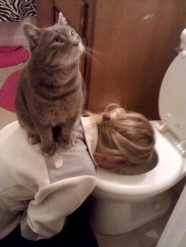 girl throwing up with cat on back