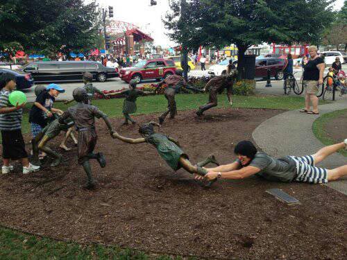 26 people having fun with statues
