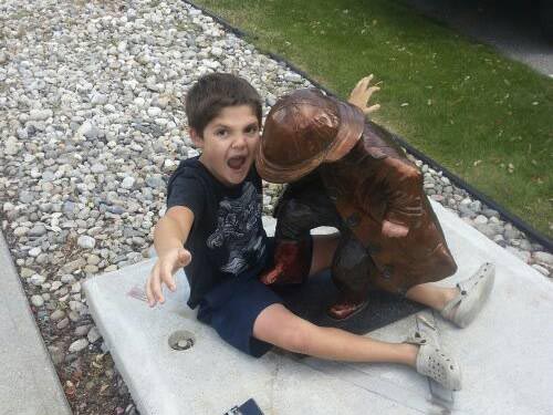 26 people having fun with statues