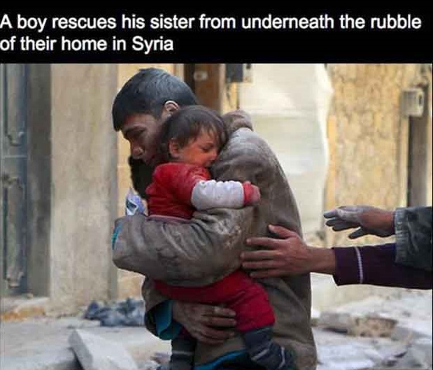 A boy rescues his sister from underneath the rubble of their home in Syria