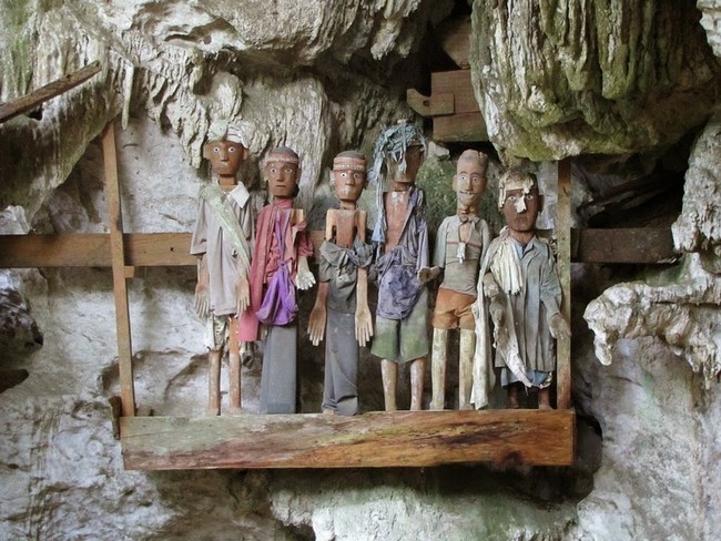 Then a "Tau Tau," a wooden effigy of the deceased, is placed on a cave wall along with those of their ancestors.