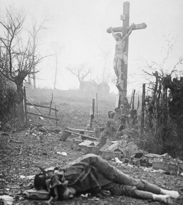One of the most shocking images photographers saw after the smoke cleared was this newly dead man laying underneath a crucifix that had strangely been left unscathed.