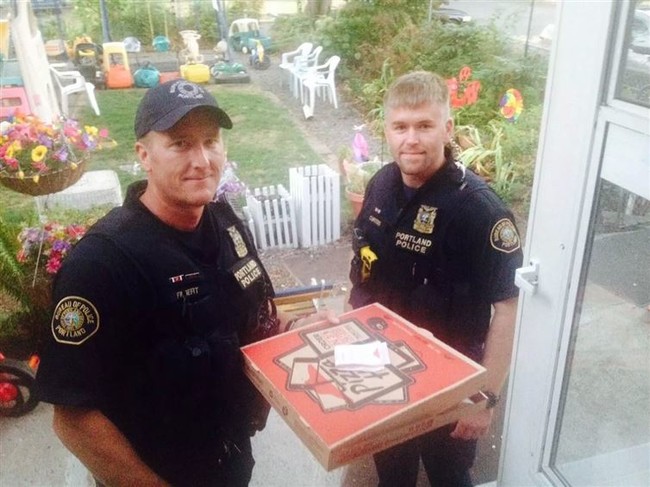 A deliveryman was involved in a collision, so these police officers delivered the pizza for him.