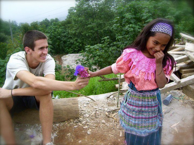 This tourist brightened a little girl's day when he handed her a flower.