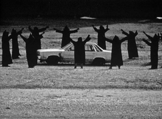 creepy vintage cult surrounding car
