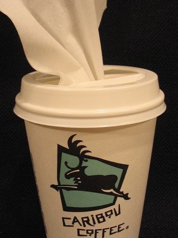 Take an old coffee cup and cut open the lid to make your own tissue dispenser.