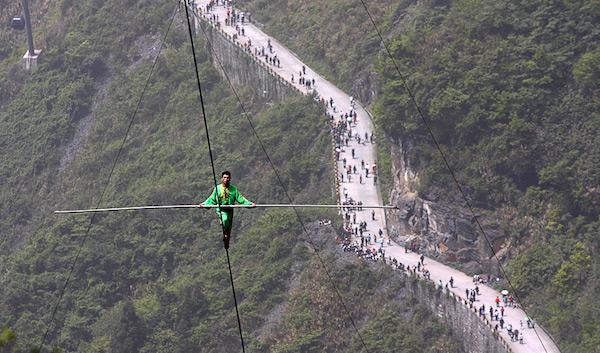 Samat Hasan, a 24-year-old stuntman from China, walked on a 2,300 ft rope with a 1.2 inches diameter and set at a 39-degree gradient and successfully broke the Guinness World Record for aerial tightrope walking.