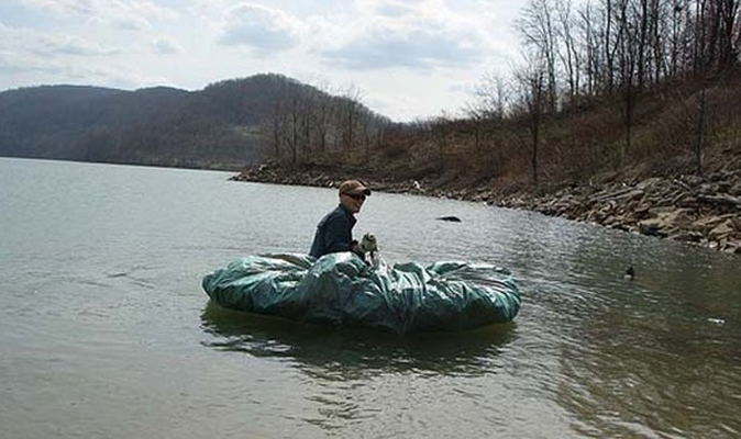 To make a small raft, cover a bunch of branches with a tarp.