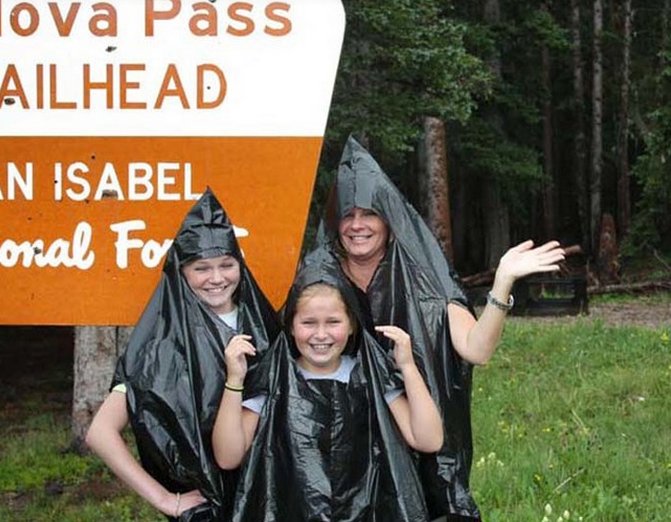 Stuck in the rain? Use trash bags with holes ripped in them as ponchos.