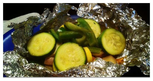 Satisfy your vegetarian guests by grilling mushrooms and zucchini in tinfoil pockets