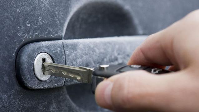 If you travel with hand sanitizer, the alcohol in it quickly loosens up frozen keyholes and door handles.