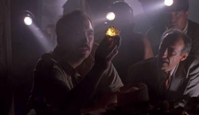 The mine we see in the beginning of the film is a small operation using low-paid workers utilizing shovels and flashlights.