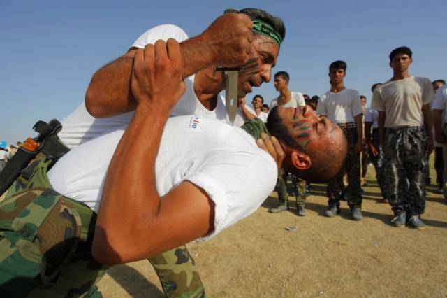Like the YPG, Iraq's Shia militias are one of the major ground forces fighting ISIS. Here, members of a militia demonstrate close-quarter combat skills at a graduation ceremony.