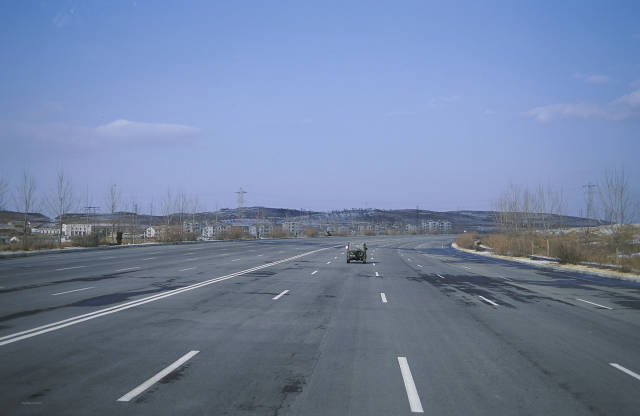 An eight-lane super highway in North Korea is almost devoid of traffic in this image taken by Swedish photographer Björn Bergman. The road – which stretches around 160km from capital Pyongyang to the border with South Korea – is also in a state of disrepair