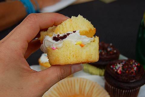 The way cupcakes are meant to be eaten: torn in half, with the icing squished like a sandwich.