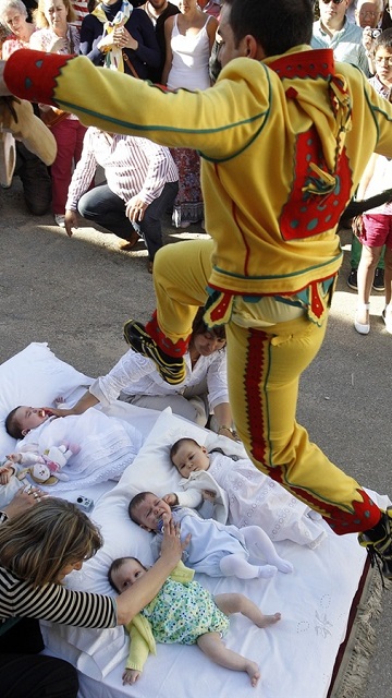 Called "El Salto del Colacho," or "the Devil's Jump," men in Burgos, Spain dress like the Devil and jump over babies born during the last year. It's a Catholic tradition thought to cleanse the infants of original sin (the fake Devil literally passes over them so the real Devil can figuratively do so), as well as provide protection throughout their life.