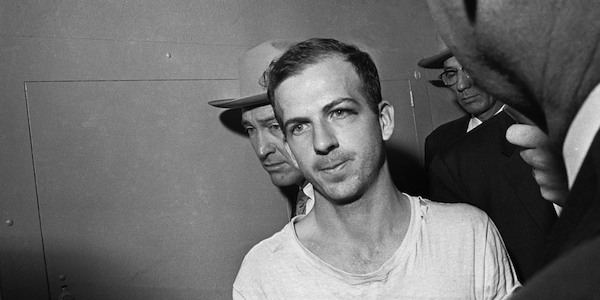 At 12:20 p.m. on November 24, 1963, in the basement of the Dallas police station, Lee Harvey Oswald, the alleged assassin of President John F. Kennedy, was shot to death by Jack Ruby, a Dallas nightclub owner. Ruby gunned the triggerman down live on NBC. 

Oswald was on his way to a more secure county jail. A crowd of police and press with live television cameras rolling gathered to witness his departure. As he came into the room, Ruby emerged from the crowd and fatally wounded Oswald with a single shot from a concealed .38 revolver. He was immediately detained and claimed that rage at Kennedy's murder was the motive for his actions. 

CBS and ABC, which had been covering the procession of Kennedy's coffin to the U.S. Capitol, aired the killing later using videotape, a rarity at the time. Ironically, parading Oswald in front of TV cameras may well have given Ruby, who died while incarcerated in 1967, his chance. "Once you made [the transport of Oswald] into a media event,” Steven D. Stark, author of Glued to the Set: The 60 Television Shows and Events That Made Us Who We Are Today, said, ”it was easy for Ruby to get inside.”

Ruby committed the first homicide ever aired live on U.S. TV. The haunting impact of Oswald's shooting and Kennedy's funeral, says Stark, "starts television on a course where it tends to become as much a part of the story as the story itself.”