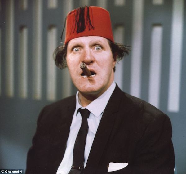 On April 15, 1984, millions tuned in to watch the hit variety show Live From Her Majesty's, only to see comedian Tommy Cooper suffer a fatal heart attack on stage. As he collapsed to uproarious applause from an audience who thought it was all part of his act, the 63-year-old Welsh comedy legend died as he had lived—making people laugh.

Cooper was in the middle of his famous magic cloak skit. Another comedian was behind the curtain passing him different props that he'd then appear to pull from inside his long flowing gown. Cooper never finished the routine. In the middle of the act, he dropped the floor and was sitting motionless and upright with his knees underneath him. 

As time ticked on, both the audience and crew members started to realize something terrible had happened. The show went to a quick commercial break. Several seconds of blank screen followed as London Weekend Television's master control contacted regional stations to get them to start transmitting commercials. Meanwhile, back on stage, desperate efforts were being made to pull the curtain around Cooper's motionless 6'3" slumped frame. 

The show continued with the remaining acts working in the limited space in front of the curtain. During a second commercial break, Cooper's body was moved to Westminster Hospital, where he was pronounced dead on arrival. The footage of his death has since been uploaded to several video sharing sites.