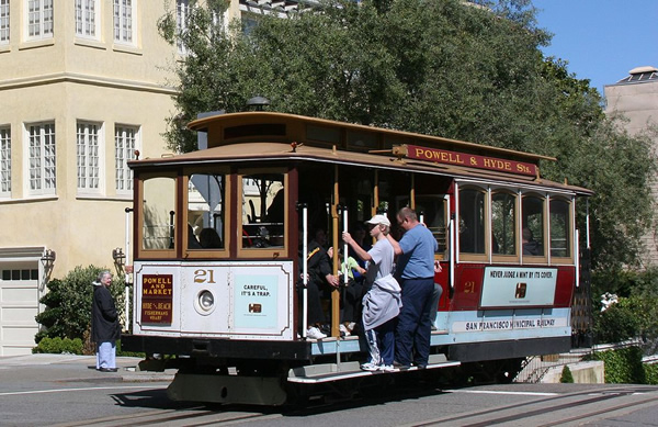 San Francisco's cable cars are part of the last manually operated cable car system in the world. An icon of the city, the cable cars form part of the intermodal urban transport network operated by the San Francisco Municipal Railway. 

Of the twenty-three lines established between 1873 and 1890, just three remain—two routes from downtown near Union Square to Fisherman's Wharf, and a third route along California Street. 

While the cars are used to a certain extent by commuters, the vast majority of their 7 million annual passengers are tourists. They are among the most significant tourist attractions in the city, along with Alcatraz Island, the Golden Gate Bridge, and Fisherman's Wharf. The cable cars are listed on the National Register of Historic Places.