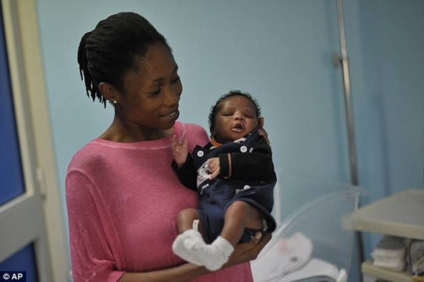 Ester Terry, from Nigeria, clutches her tiny son Khalifa Nyka at Catania, Italy's Cannizzaro Hospital.

The 24-year-old was attempting to cross the Mediterranean in a dilapidated dinghy with 100 other migrants and refugees when she went into labor. As contractions gripped her body, panic exploded around her as the overcrowded dinghy began to take on water. The Italian Coast Guard launched a dramatic rescue to save the desperate group from the sea. 

Incredibly while still at sea, Ester managed to safely give birth to her little boy with the help of a doctor aboard the Italian rescue vessel. The boy was born as the boat made its way to Lampedusa, Italy's southernmost island. 

The woman is one of 300,000 refugees and migrants who have crossed the Mediterranean into Europe this year, up from 219,000 in 2014.