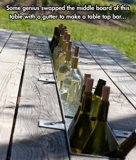 Some genius swapped the middle board of this table with a gutter to make a table top bar...