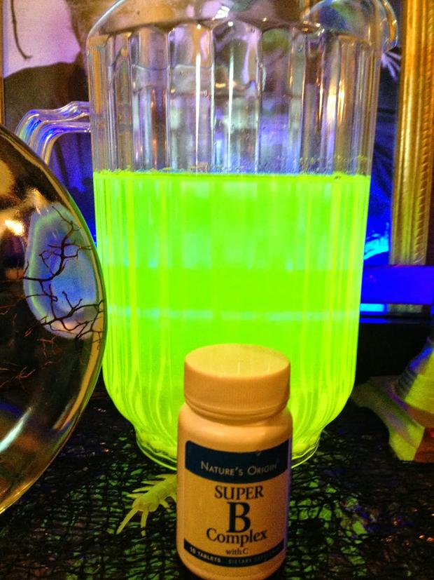 This toxic looking sludge is actually just normal punch with B Complex vitamins mixed in. The only caveat: you'll need to keep a black light nearby to actually make it glow.