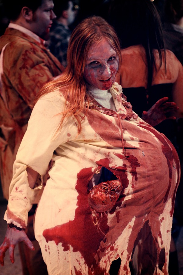 If there's anything creepier than a zombie, it's a pregnant zombie with an undead baby climbing out of her belly. This incredible costume photographed by Flickr user Ginny is particularly wicked and the fetus looks strangely similar to the Cryptkeeper from Tales From the Crypt.