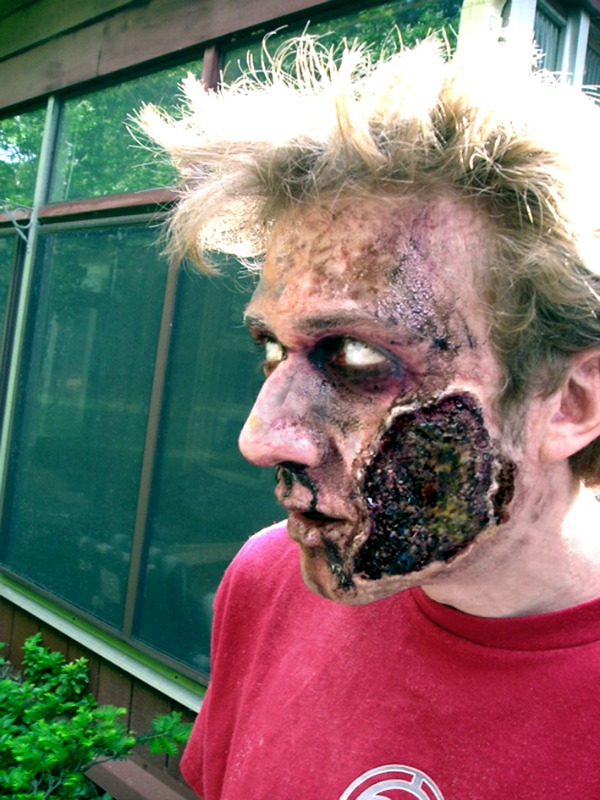 The great part of being undead is that you keep living on for years. This gross zombie makeup by Andrew Lavin looks like time has worn on, and his skin has been left to rot.
