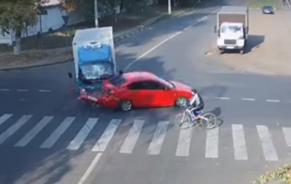 Cyclists risk their lives every time they hit the road, which is why they have to keep their wits about them. But, no matter how vigilant the biker is, there's always the possibility of being involved in a wreck thanks to irresponsible drivers. 

One Russian bicyclist became sandwiched between a car and a delivery truck when the vehicles crashed at an intersection. Thanks to CCTV cameras, the cyclist survived without a scratch and now has proof of his incredible luck.