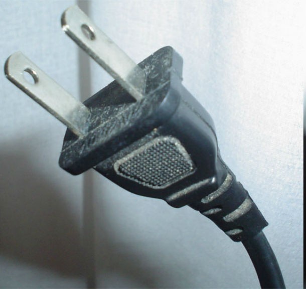 If you can’t find a flathead screwdriver, use a plug. Basic power plugs usually fit medium and large-sized screws.