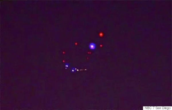Lens flare or UFO? 

Several callers phoned into San Diego's NBC News affiliate on April 28, 2015, to inquire about this unusual, colorful grouping of aerial lights that were captured over San Ysidro, close to the U.S.-Mexico border. 

"Some said they appeared to be red, blue, and green and kept flashing and changing colors. Some who saw them say the lights didn't seem to move, like those on a plane or a drone," NBC 7 San Diego reported. "We put in calls to the military here to see if they could identify what these were. So far, no response."

However, after UFO researchers and The Huffington Post called the station to ask for more information, they were all of sudden tight-lipped. 

OpenMinds.tv investigative reporter Alejandro Rojas thinks he knows why: "We have received several comments pointing out how similar the light configuration in the sky is to the lights on the ground, suggesting that the lights that appear in the sky are actually just a lens flare."

"Bright lights can sometimes be reflected in the lens of the camera. In particular, a tower light can be seen pulsing at the top of a tower on the ground. One of the red lights in the sky pulses in the same manner. However, it doesn't pulse at the same time."