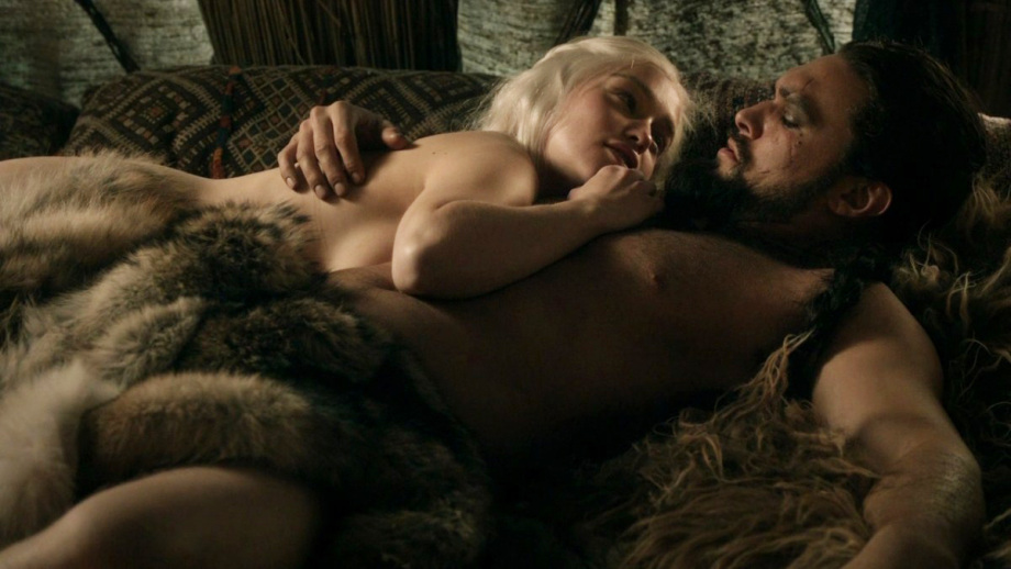 Emilia Clarke and Jason Momoa (Game of Thrones)
Much like Wilde did, Momoa goofed around a bit with his private parts. Instead of using the normal modesty sock to cover up, he chose a fluffy pink sock, which sent Clarke into a hysterical fit of the giggles. She said, “It’s huge, and it’s pink, and I don’t know what to do.”