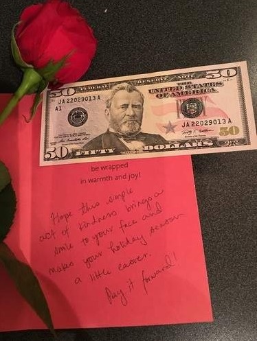 Young girl surprises stranger with a card containing $50 and a powerful note, handing it to him while he was out walking his dog. He decided to pay it forward, giving it to his local food pantry.
