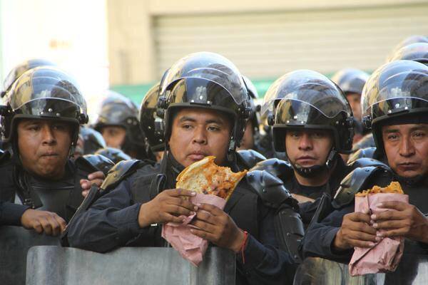 Mexican police having quesadillas for lunch break during protests