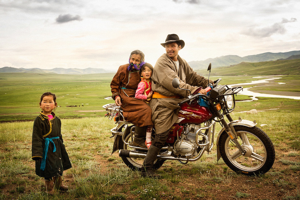 A Mongolian nomad family traveling by motorcycle Photo by Brian Hodges